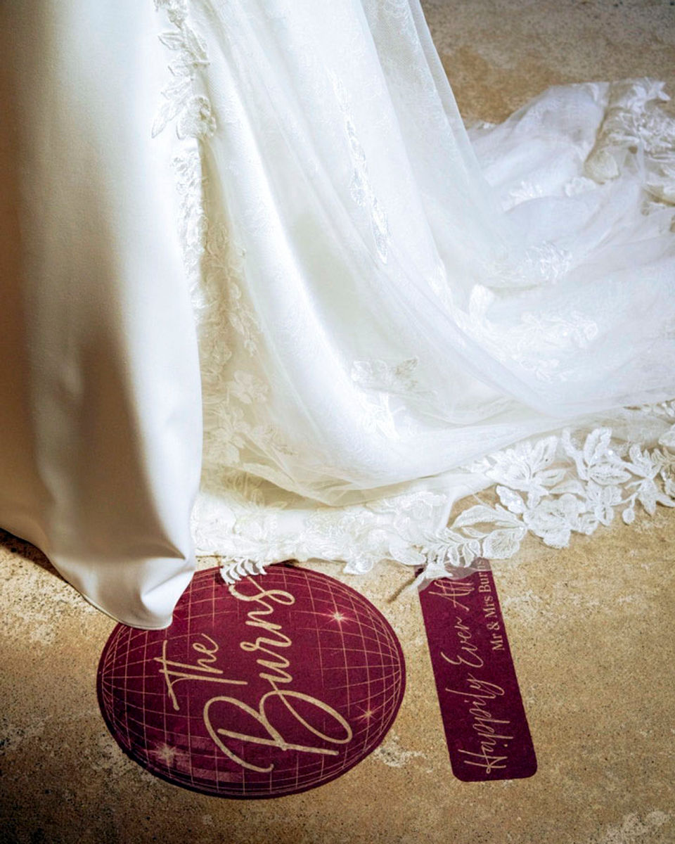 Personalised wedding signs styled beside a wedding dress